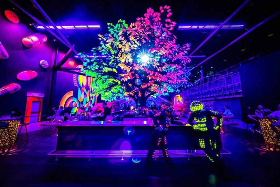 cocktails & conversation under the glow of a digital forest
