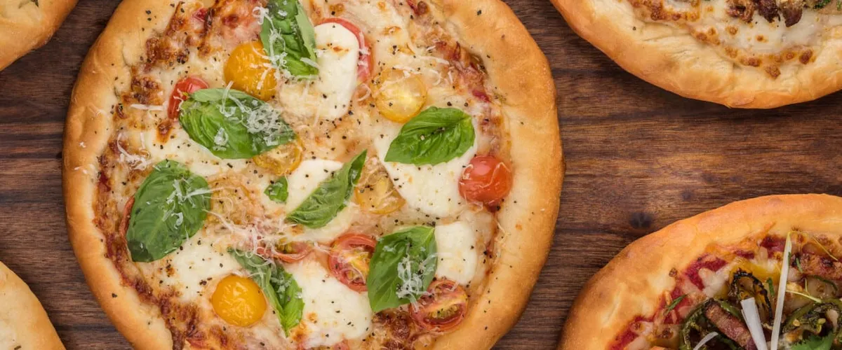 Fresh pizza with basil, tomato and egg.