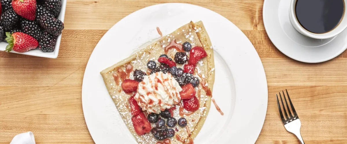 Crêpes with strawberries, blueberries, black berries and whippe